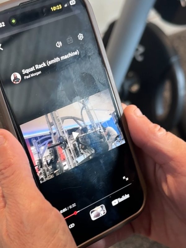 The Coach Morgan app playing a Smith machine squat demo video