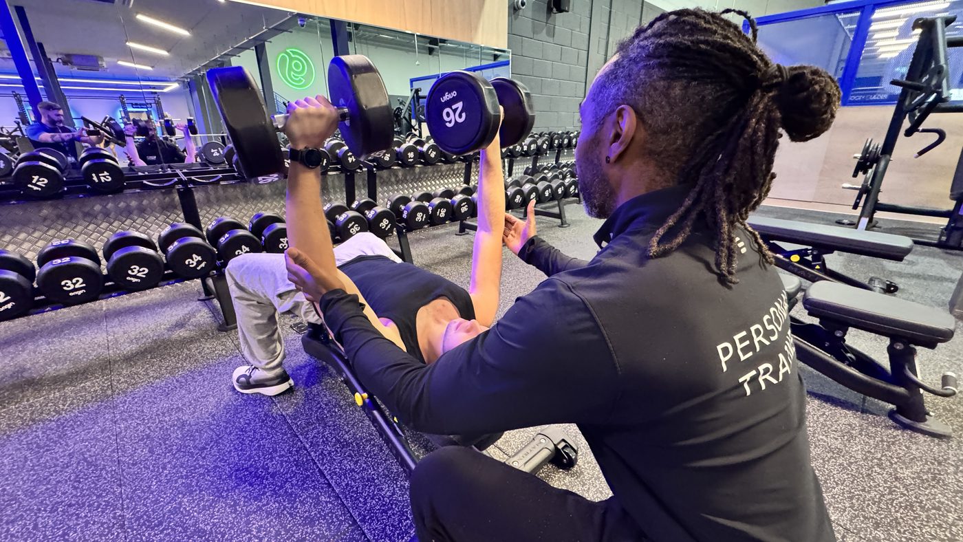 Paul coaching a client through a dumbbell chest press