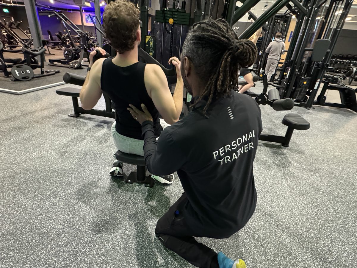 Paul coaching a client on the lat pulldown